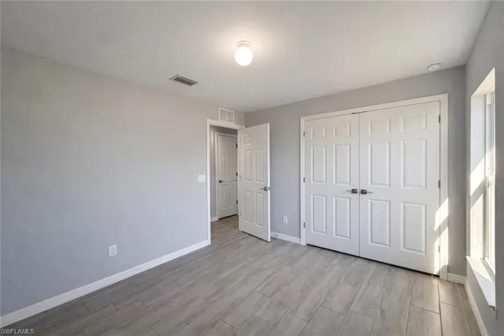 Unfurnished bedroom featuring a closet and light wood finished floors