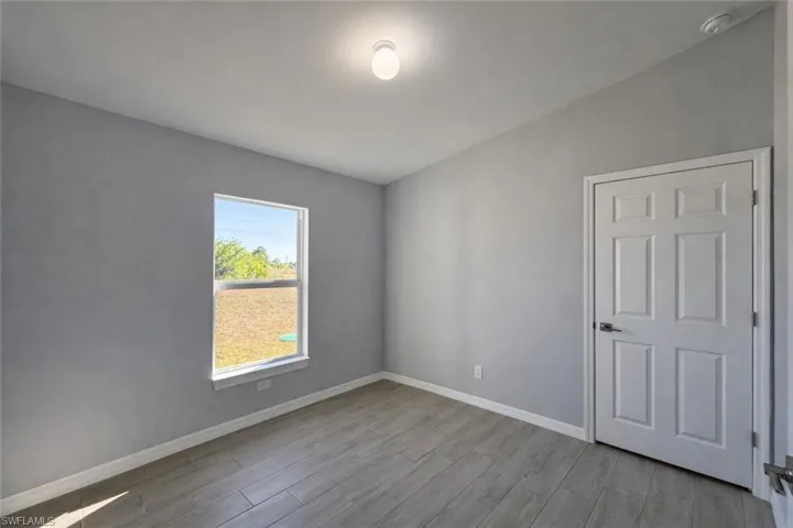 Empty room with light wood finished floors and baseboards