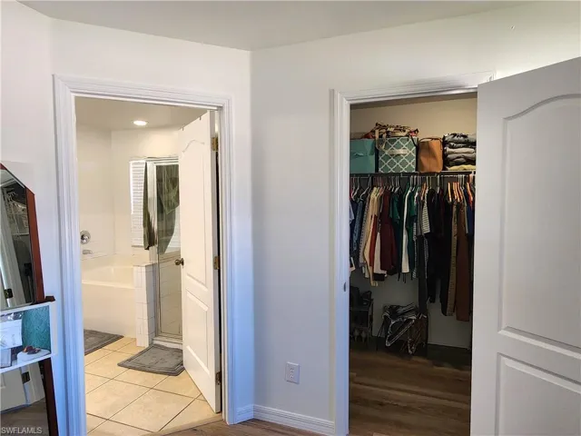 Entrance to deep walk-in closet and ensuite.