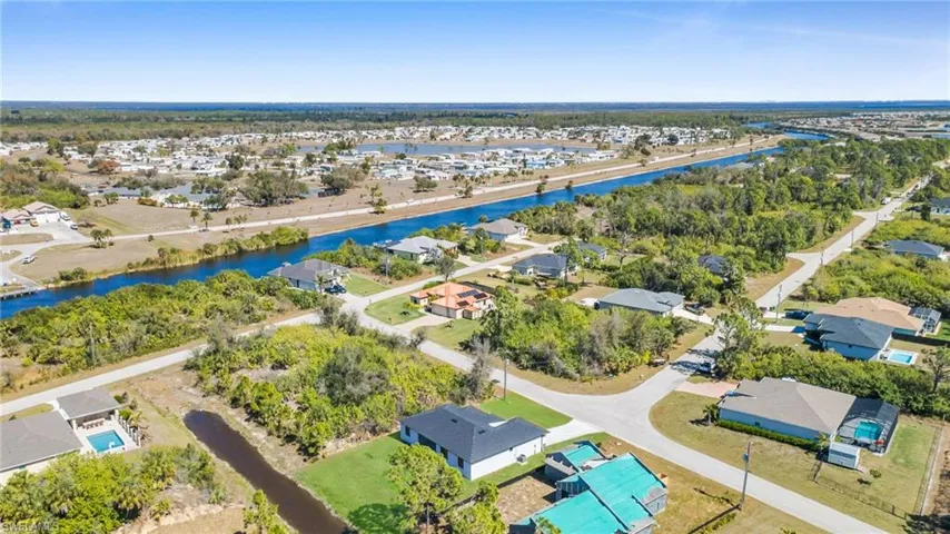 Aerial perspective of suburban area with a large body of water