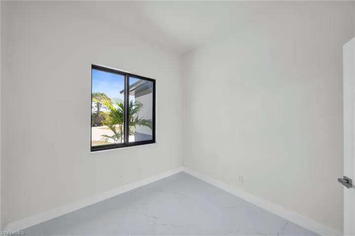 Empty room with baseboards and marble finish floors
