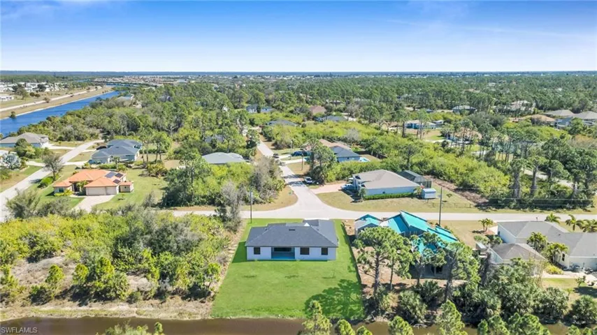 Aerial perspective of suburban area with a nearby body of water