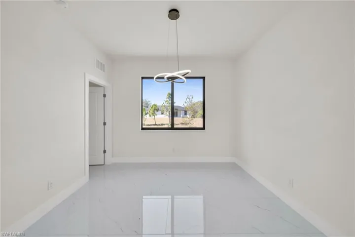 Empty room with light marble finish floors and baseboards