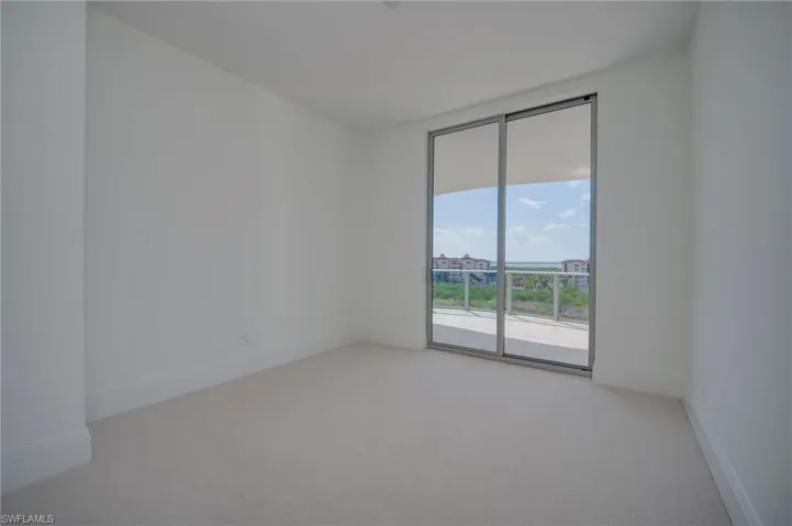 Unfurnished room with light carpet and baseboards