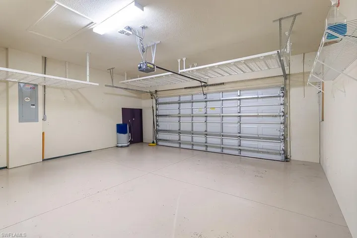 2 car garage with storage racks and epoxy flooring
