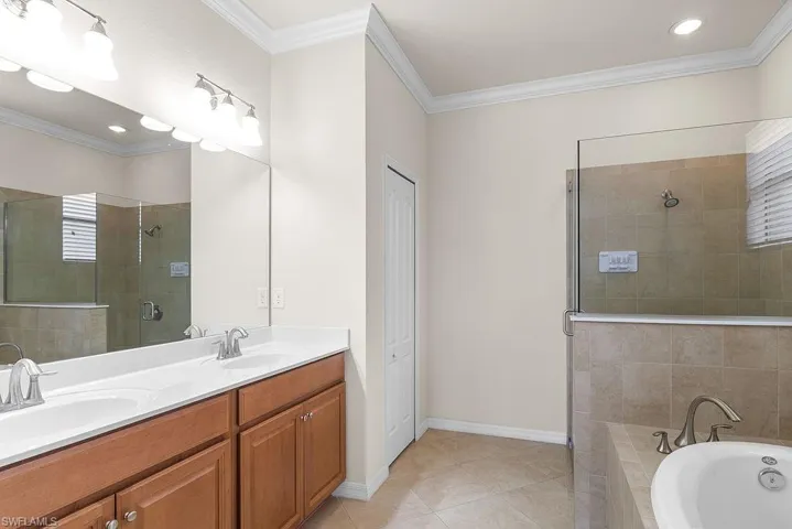 Primary ensuite with dual sinks and frameless glass shower