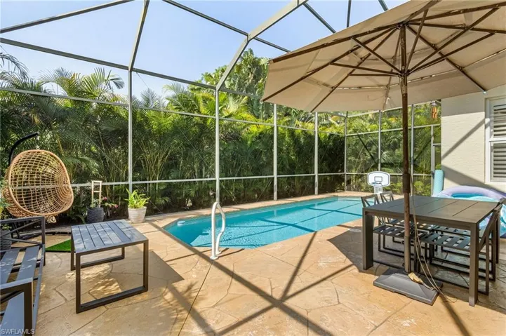 View of pool with a lanai and a patio area