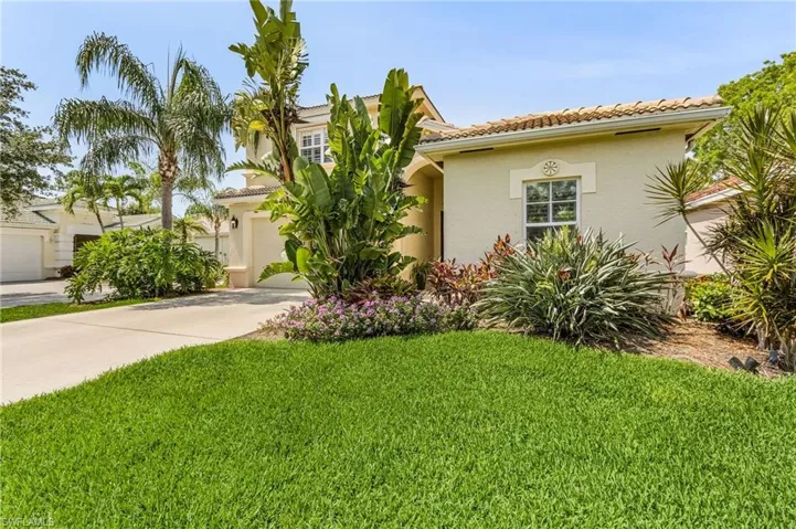 Mediterranean / spanish-style house with a front lawn and a garage