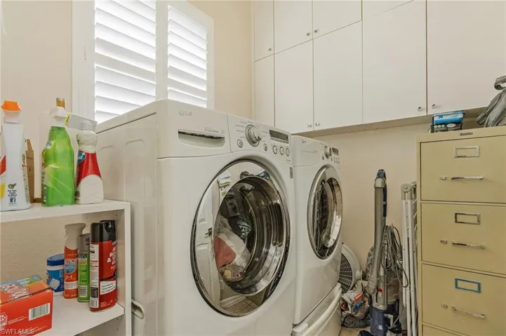 Laundry area featuring washer and dryer and cabinets