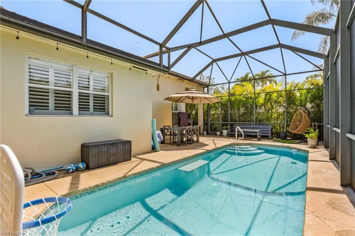 View of swimming pool with a patio and a lanai