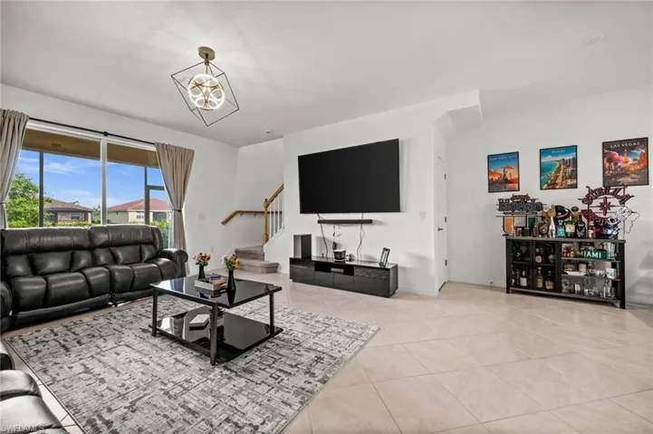 Living room featuring stairway and tile patterned flooring