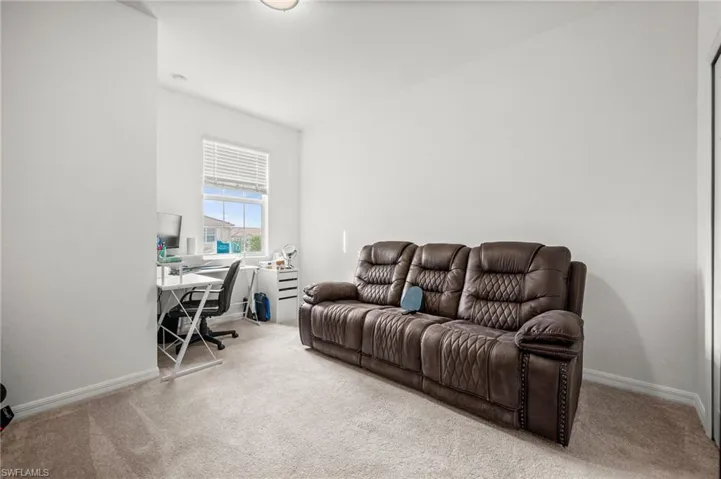 Office featuring light colored carpet and baseboards