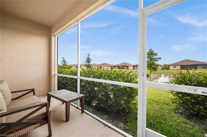 Unfurnished sunroom featuring a residential view and a water view