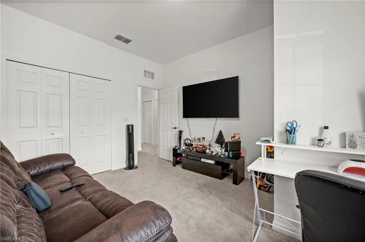 Living area featuring light carpet