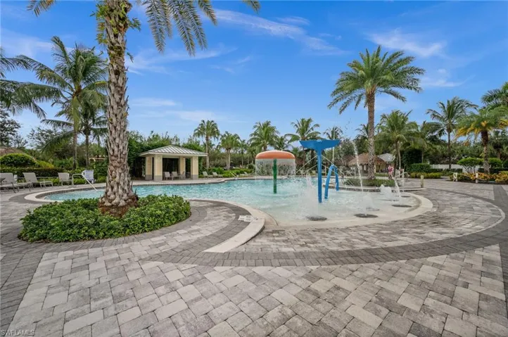 Community pool featuring a water play area, a gazebo, and a patio area