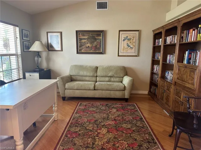 Living area featuring light wood-type flooring and visible vents