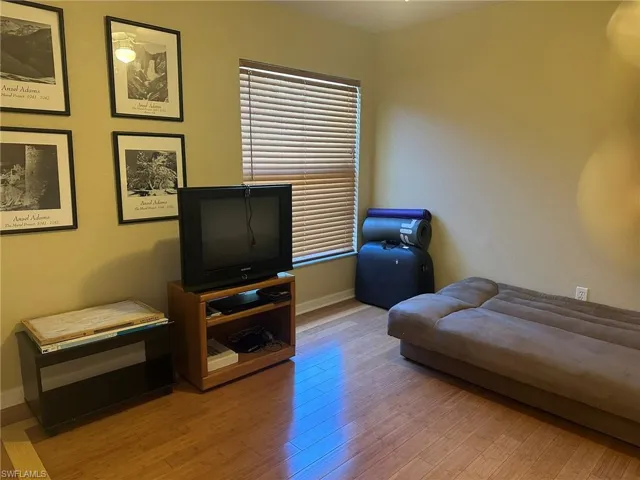 Living area with baseboards and light wood-type flooring