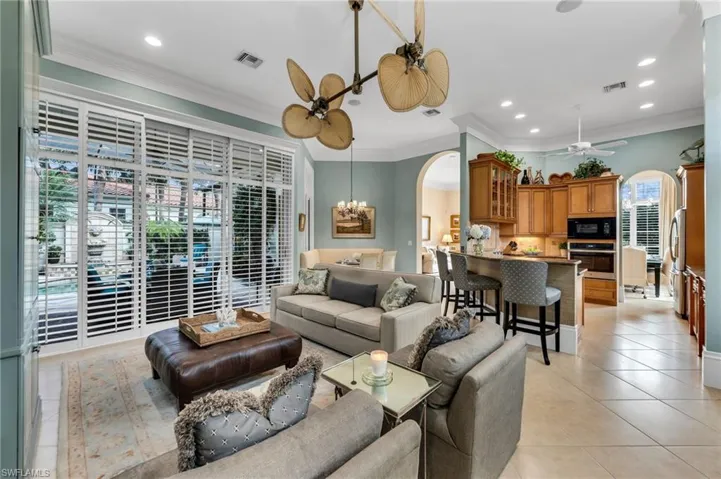 High ceilings, generous crown moldings, and neutral tile flooring...