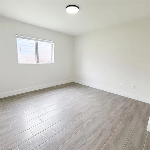 Spare room with wood tiled floors and baseboards
