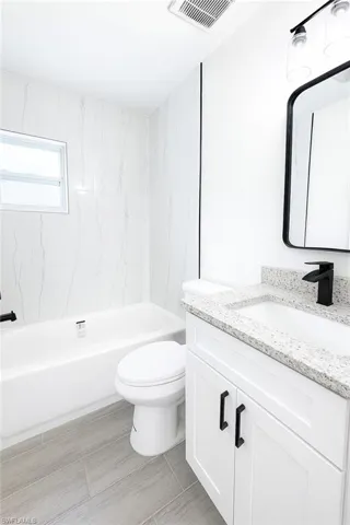 Bathroom with vanity and shower / bath combination