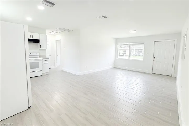 Unfurnished living room with light wood-type flooring and recessed lighting