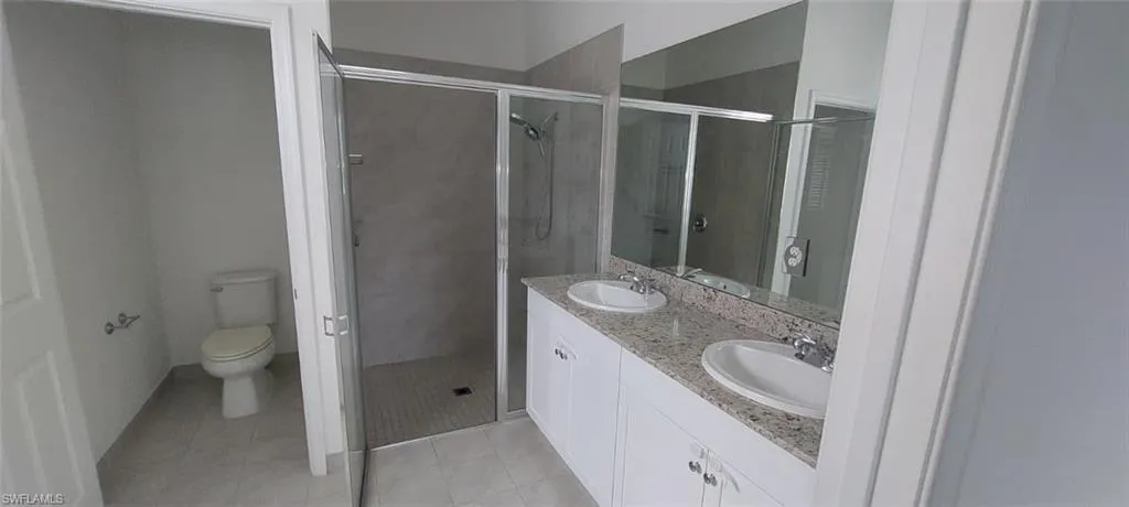 Dual vanity with granite countertops, undermount sinks, and chrome faucets