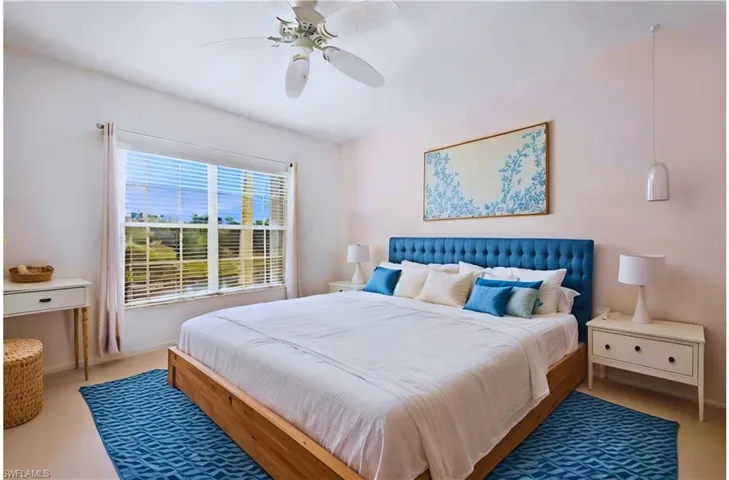 Carpeted bedroom featuring ceiling fan