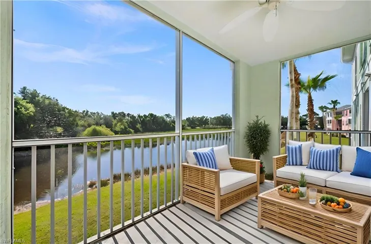 Sunroom with ceiling fan, a water view, and a wealth of natural light