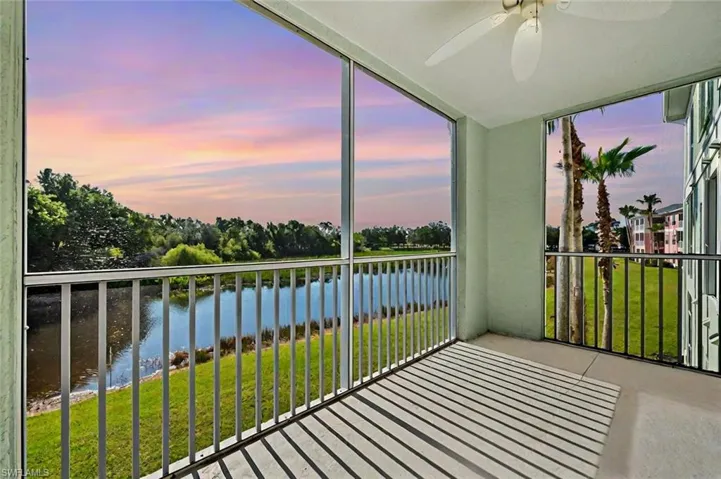 Unfurnished sunroom featuring a water view and a ceiling fan