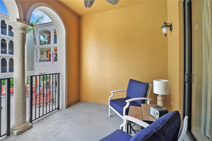 Living area featuring carpet flooring and decorative columns
