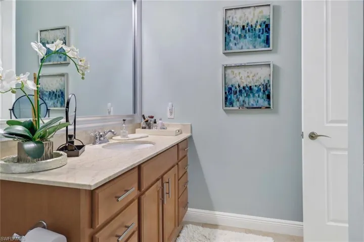 Bathroom with tile patterned flooring and vanity
