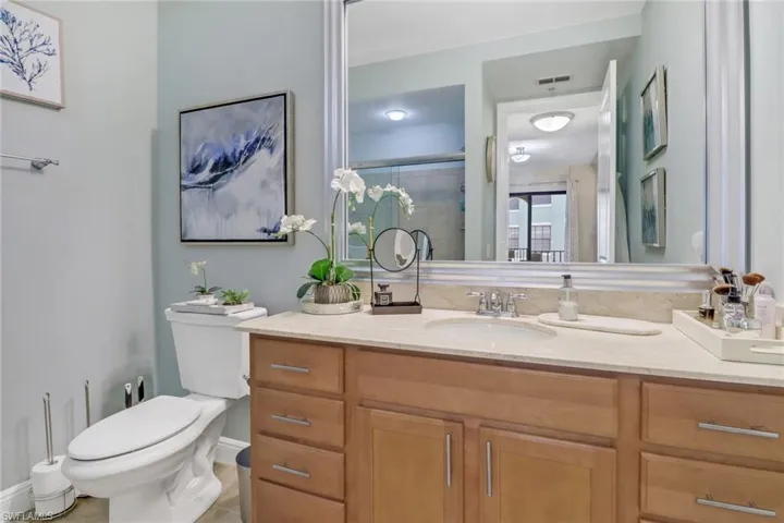 Bathroom with tile patterned flooring, toilet, and vanity