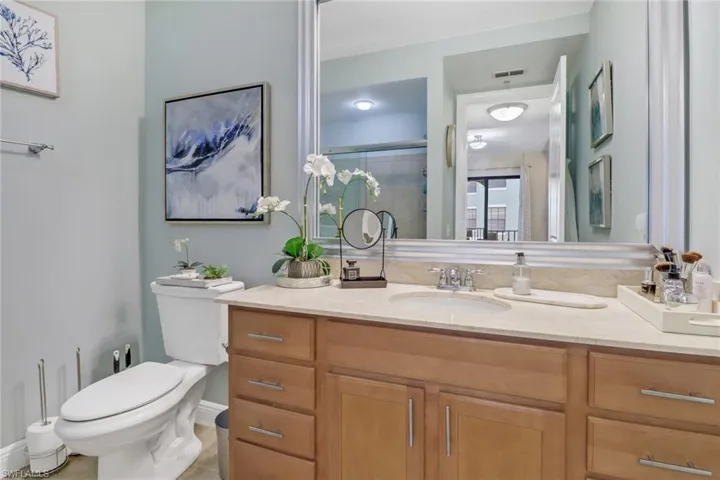 Bathroom featuring tile patterned floors, toilet, and vanity