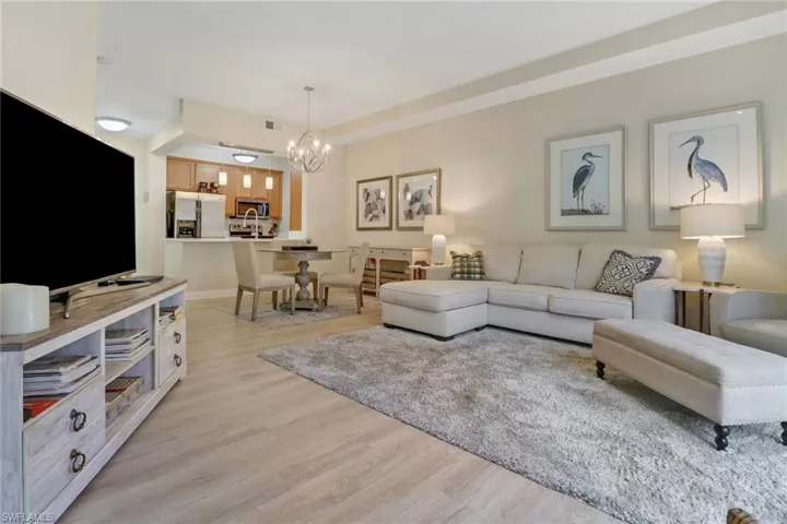 Living room with a chandelier and light hardwood / wood-style flooring