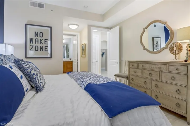 Bedroom featuring hardwood / wood-style floors and ensuite bathroom