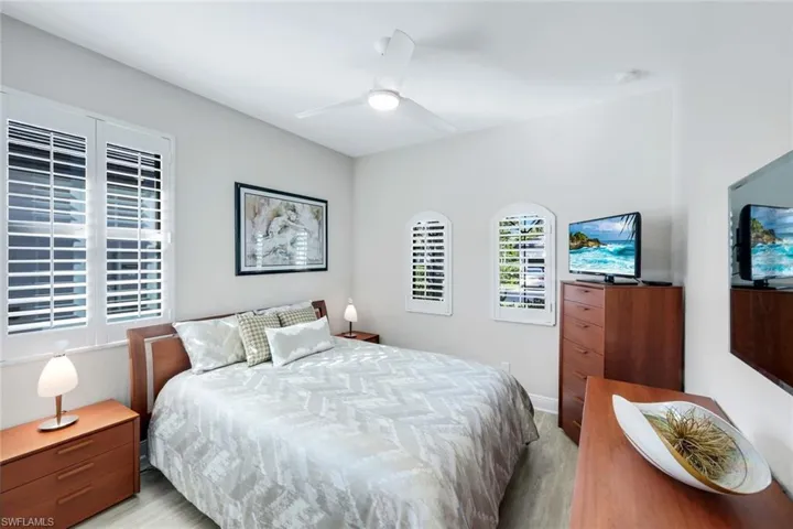 Bedroom with ceiling fan and wood finished floors