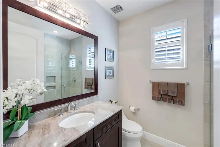 Bathroom with vanity and a stall shower