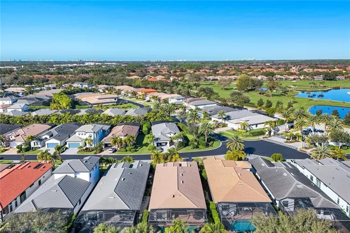 Aerial view of property's location featuring a large body of water and nearby suburban area
