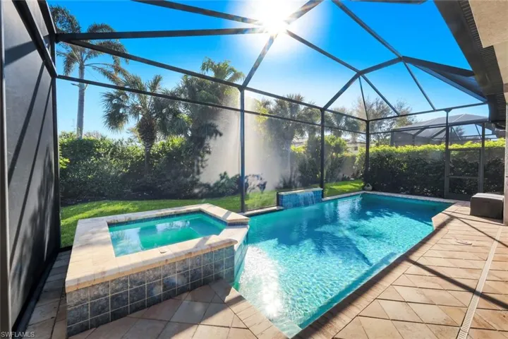 Integrated pool / spa featuring a patio, a sunroom, and glass enclosure