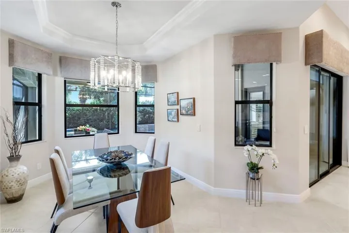 Dining area featuring suspended lighting and crown molding
