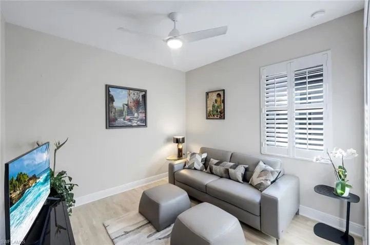 Living area with wood finished floors and ceiling fan