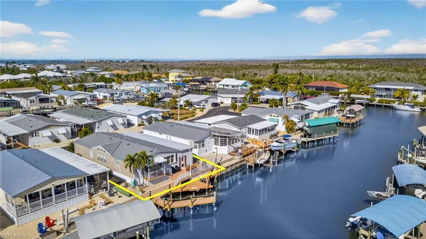Aerial view of residential area featuring a nearby body of water