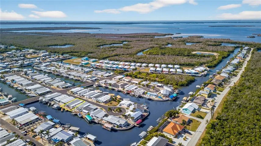 Aerial view of property's location featuring a large body of water and nearby suburban area