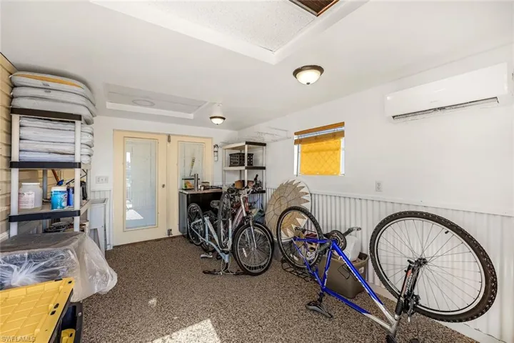 Storage room featuring a wall mounted air conditioner