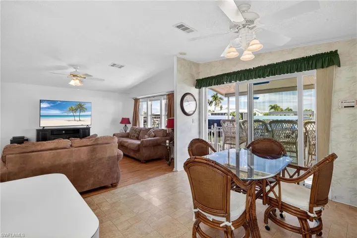 Breakfast area featuring ceiling fan, a textured ceiling, and lofted ceiling