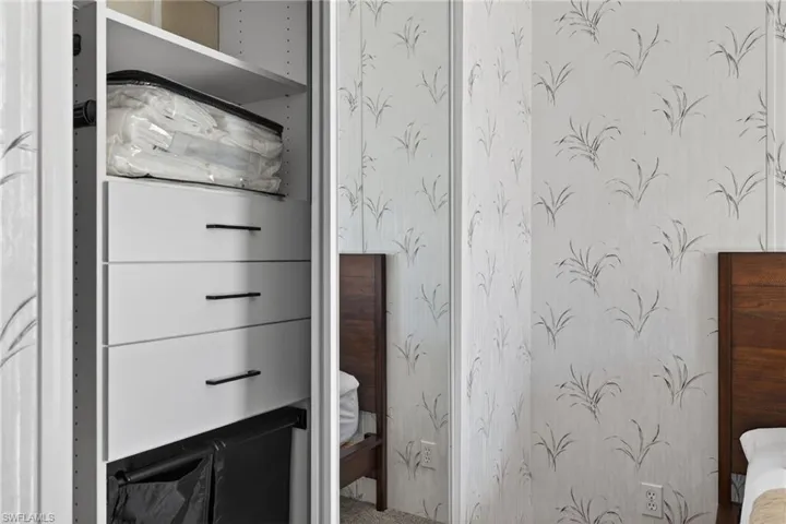 Bedroom featuring wallpapered walls