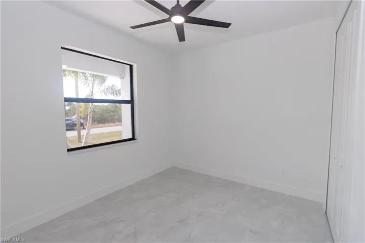 Bedroom with baseboards and a ceiling fan