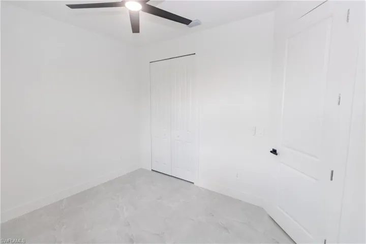 Bedroom featuring a closet and a ceiling fan
