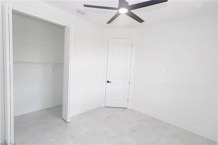 Bedroom featuring a ceiling fan and a closet