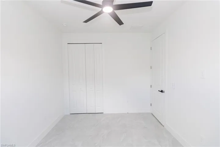 Bedroom with a closet and a ceiling fan